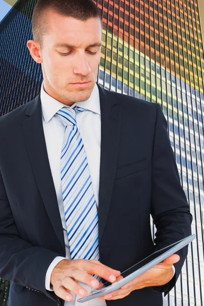 Composite image of businessman using tablet — Stock Photo, Image