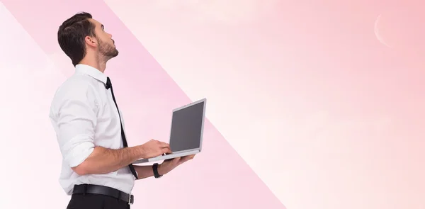 Businessman standing using laptop — Stock Photo, Image