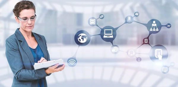 Businesswoman writing on clipboard — Stock Photo, Image