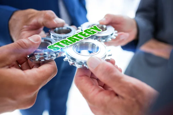 Business colleagues holding cogs — Stock Photo, Image
