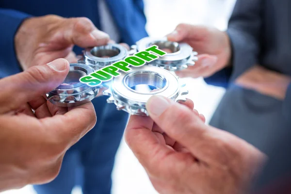 Business colleagues holding cogs — Stock Photo, Image