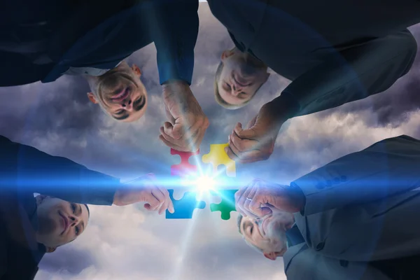 Business colleagues holding piece of puzzle — Stock Photo, Image