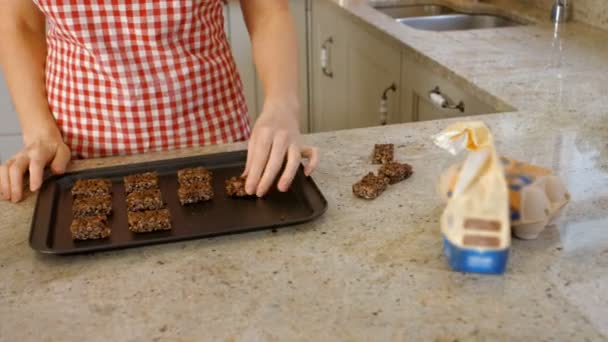 Vrouw zetten koekjes op een bakplaat — Stockvideo