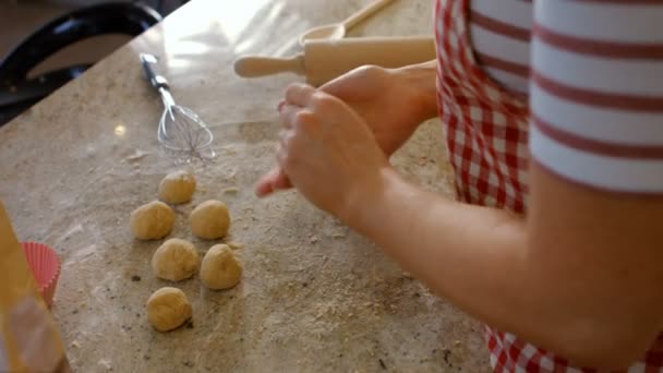 Woman forming balls with dough — Stock Video