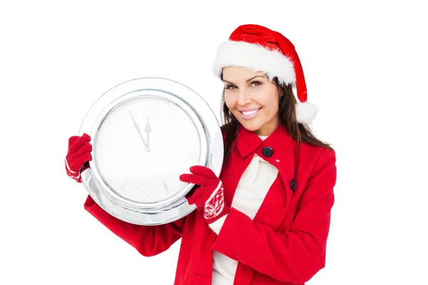 Brunette with santa hat on holding a clock — Stock Photo, Image