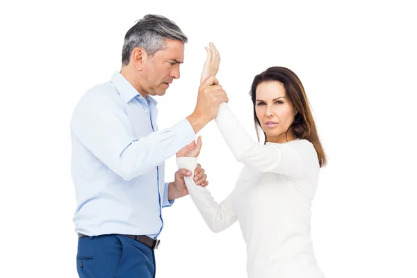 Violent man grabbing wife's wrists — Stock Photo, Image