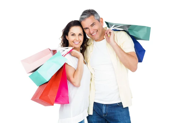 Attractive couple holding shopping bags — Stock Photo, Image