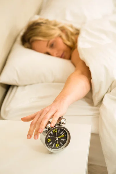 Woman shutting off  alarm clock — Stock Photo, Image