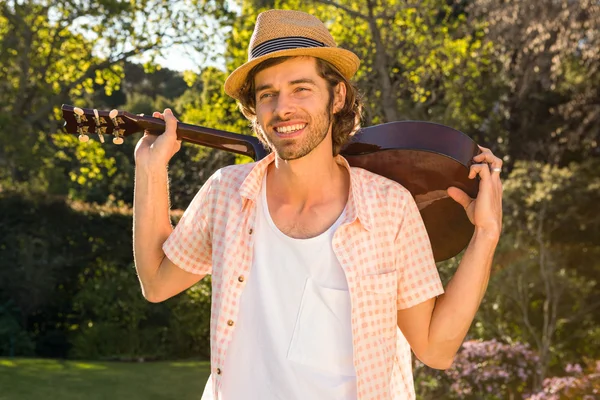 Handsome man holding  the guitar — Stock Photo, Image