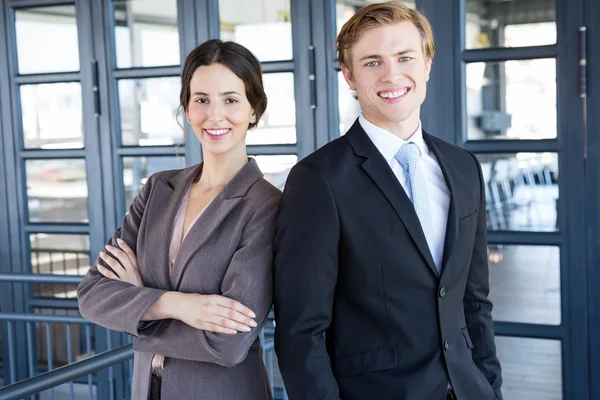 Businessman and businesswoman standing — Stock Photo, Image