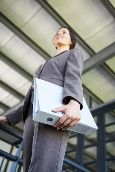 Young businesswoman holding folders — Stock Photo, Image