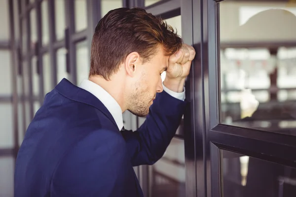 Cansado empresário inclinado na porta — Fotografia de Stock