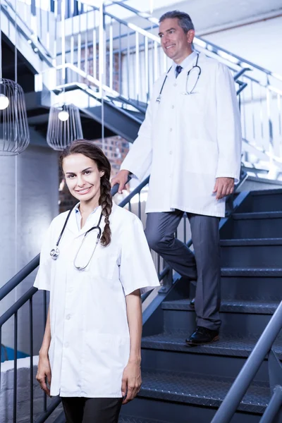 Doctors walking down stairs — Stock Photo, Image