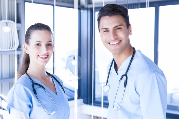 Doctors smiling at camera — Stock Photo, Image