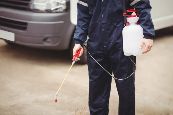 Handyman with insecticide standing outdoors — Stock Photo, Image