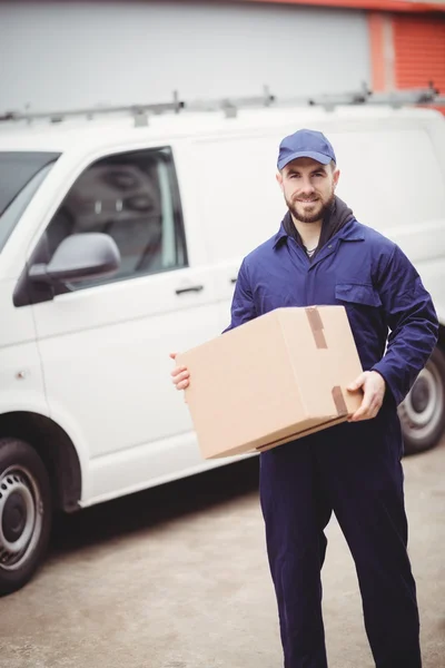 Delivery man holding box — Stock Photo, Image