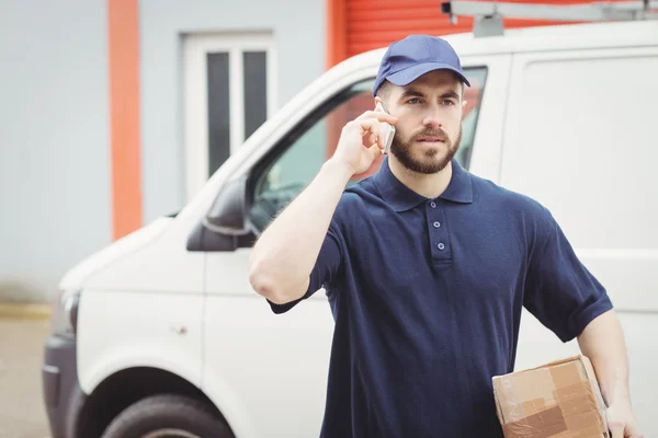 Delivery man making a phone call — Stock Photo, Image