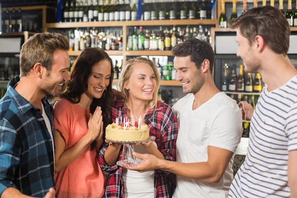 Friends in a circle holding a cake — Stock Photo, Image