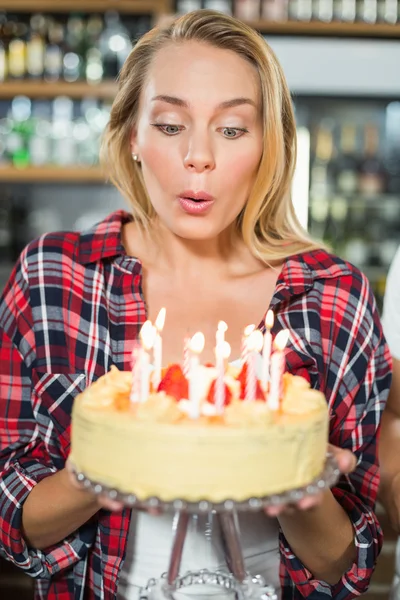 Woman blowing out candles — Stock Photo, Image