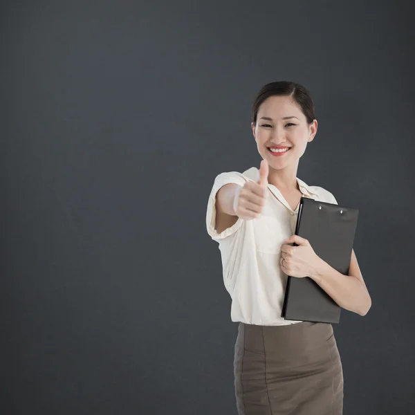 Woman gesturing thumb up — Stock Photo, Image
