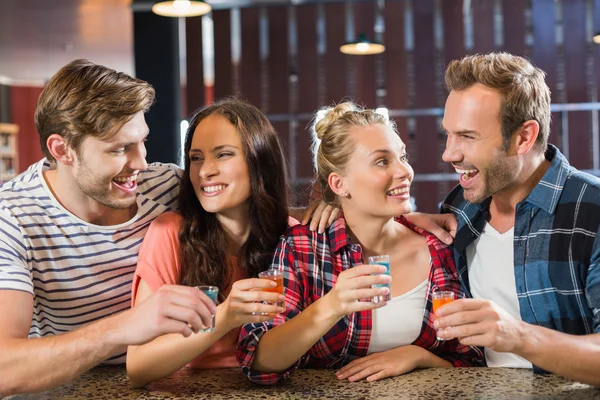 Friends laughing with shots — Stock Photo, Image