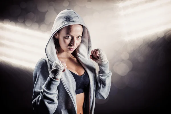 female boxer in hood with fighting stance