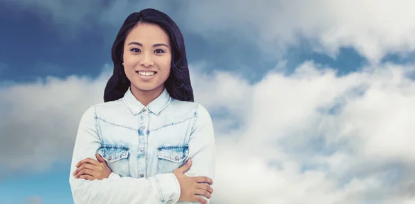 Asian woman with arms crossed smiling — Stock Photo, Image