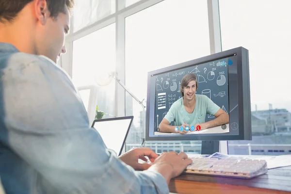 Businessman using computer at desk in creative office — Stock Photo, Image