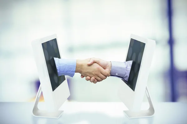 Composite image of hand shake in front of wires — Stock Photo, Image