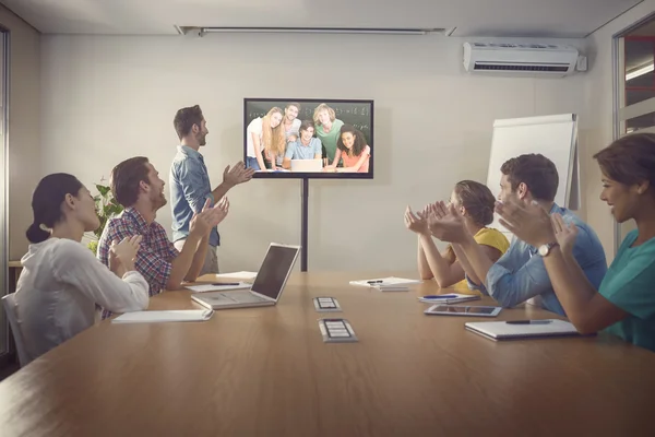 Students in computer class against business people — Stock Photo, Image