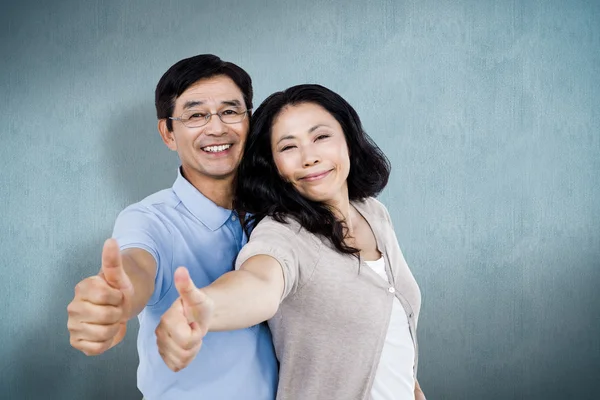 Couple standing together with thumbs up — Stock Photo, Image