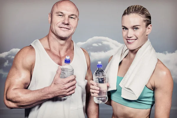 Athlete man and woman with water bottle — Stock Photo, Image