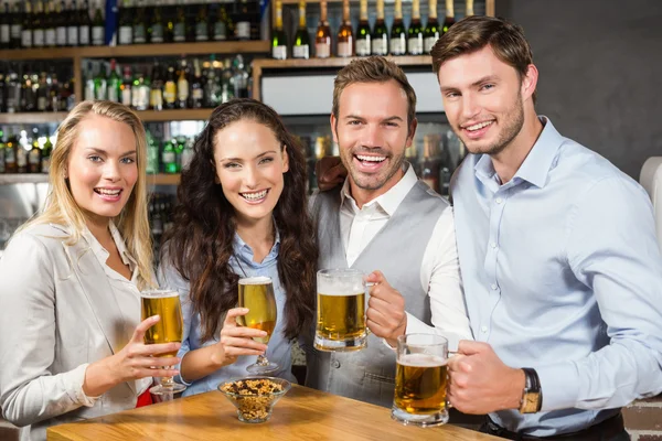 Friends toasting while looking at camera — Stock Photo, Image