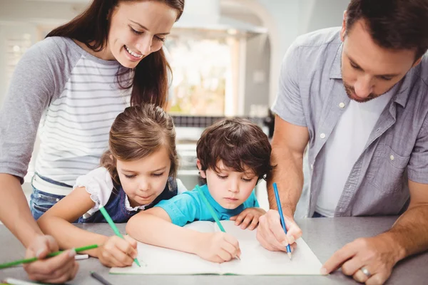 Family writing in book while standing — Stock Photo, Image