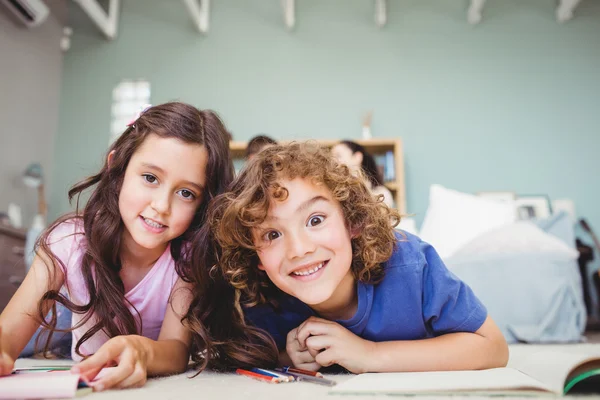Children smiling while studying at home — Stock Photo, Image