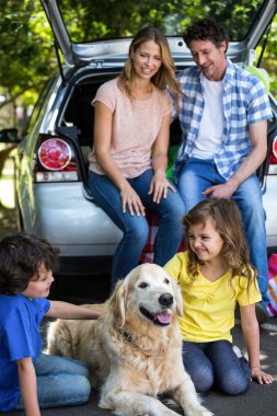 Children ruffling the dogs fur clipart