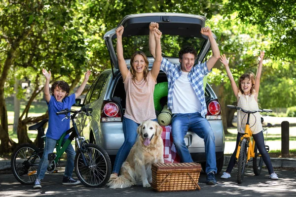 Smiling family with arms up — Stock Photo, Image