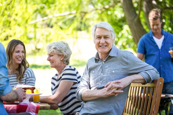Family and friends having a picnic with barbecue — Stock Photo, Image