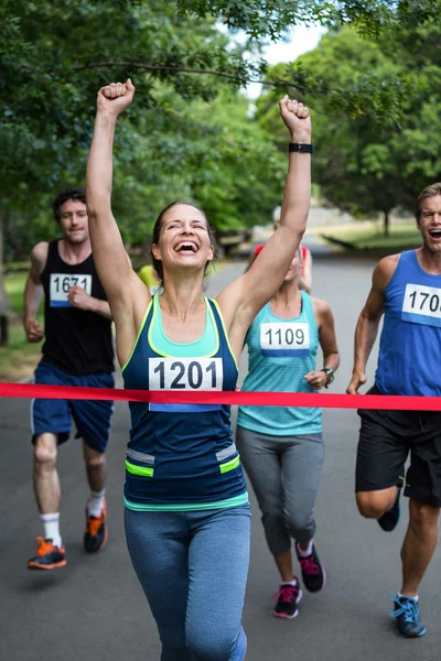 Happy woman crossing the finish line — Stock Photo, Image