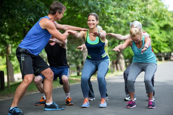 Fitness class doing squat sequence — Stock Photo, Image