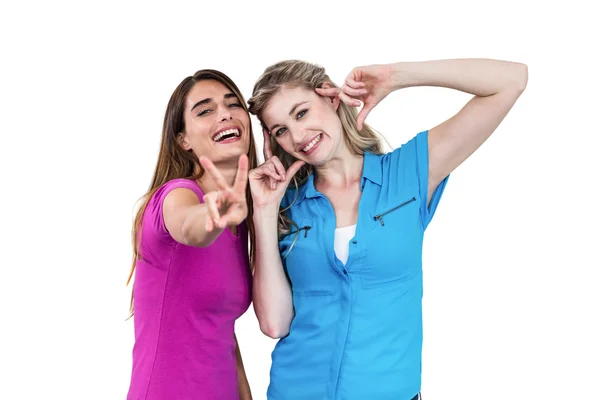 Smiling female friends gesturing — Stock Photo, Image