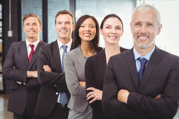 Businesspeople standing with arms crossed — Stock Photo, Image