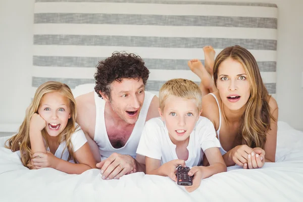 Family relaxing on bed at home — Stock Photo, Image