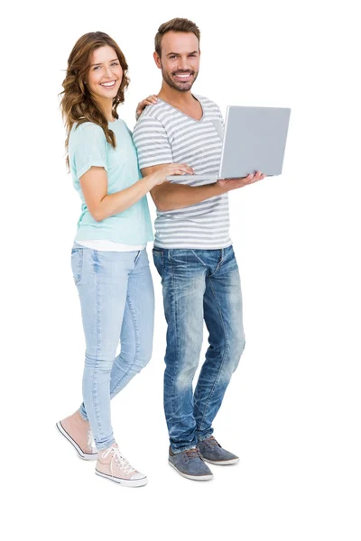 Young couple using laptop — Stock Photo, Image