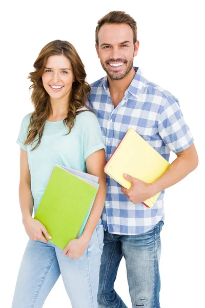 Casal segurando livros e pastas — Fotografia de Stock