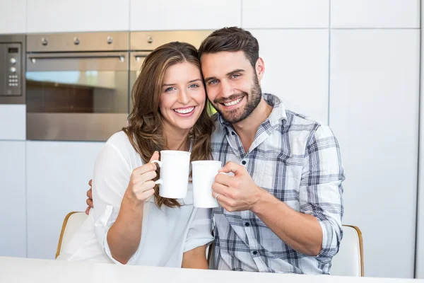 Couple drinking coffee by table — Stock Photo, Image