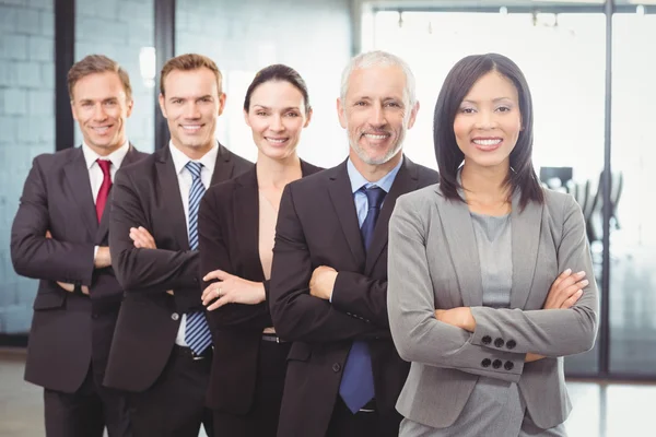 Businesspeople standing with arms crossed — Stock Photo, Image