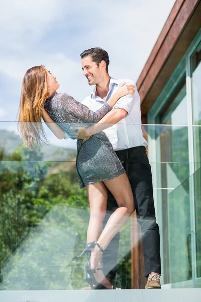 Romantische koppel dansen op balkon in resort — Stockfoto