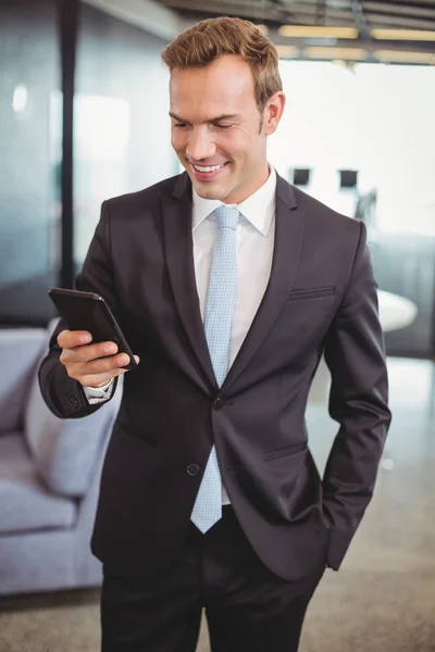 Businessman looking at mobile phone — Stock Photo, Image