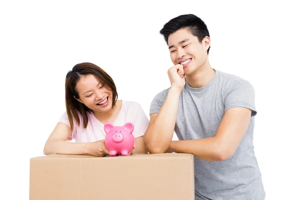 Couple looking at piggy bank — Stock Photo, Image